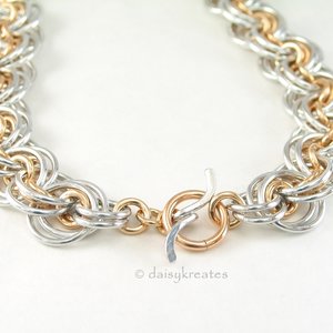 Necklace closes with gold tone toggle ring and silver tone Wave toggle bar
