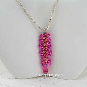 The Ruffly Ribbon Strangemaille Pendant nicely dresses up white or any light col